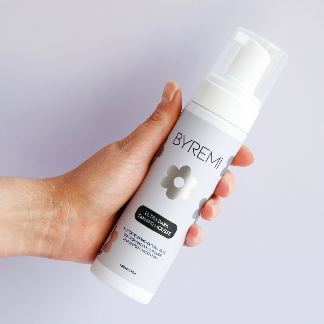 model holding bottle of byremi nz best self tan in ultra dark