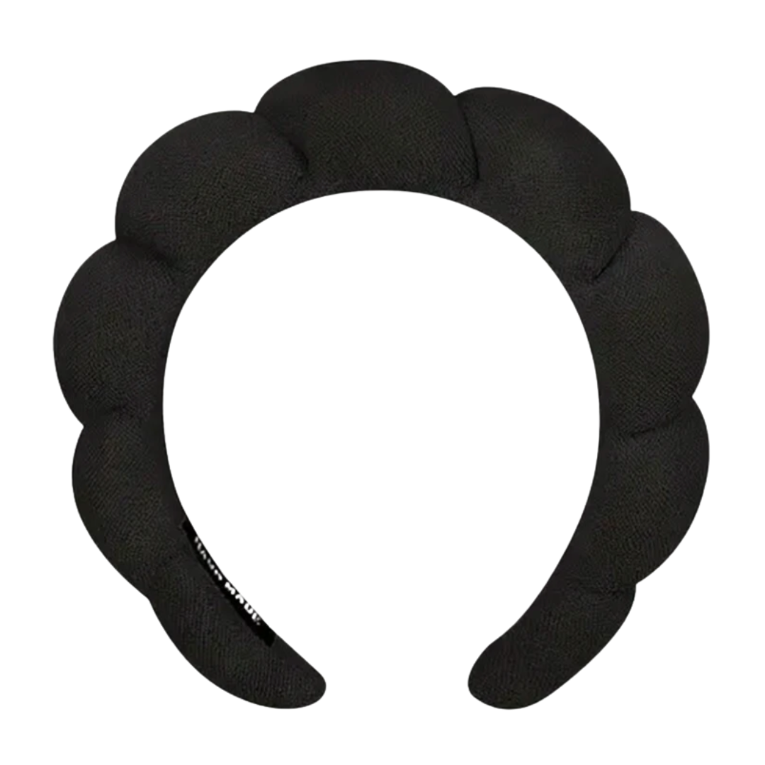 Black headband with textured design on a white background - self tan.