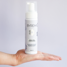 model holding bottle of byremi nz best self tan in the medium dark